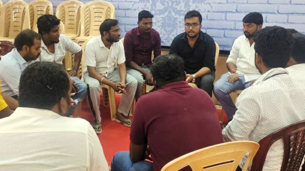 Rafiq leading a discussion with volunteers, emphasizing community building and social media skills.